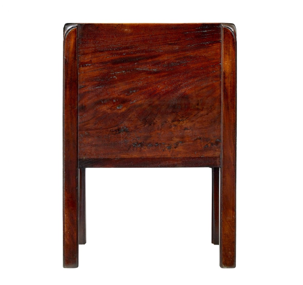 A 19th-century Georgian mahogany bedside table featuring a gallery top with hand-holds, a sliding tambour door, and a drawer with a brass handle. View V
