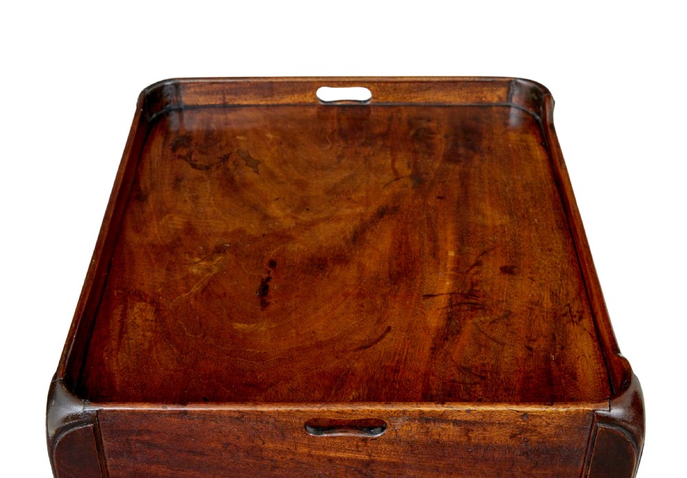 A 19th-century Georgian mahogany bedside table featuring a gallery top with hand-holds, a sliding tambour door, and a drawer with a brass handle. View VII