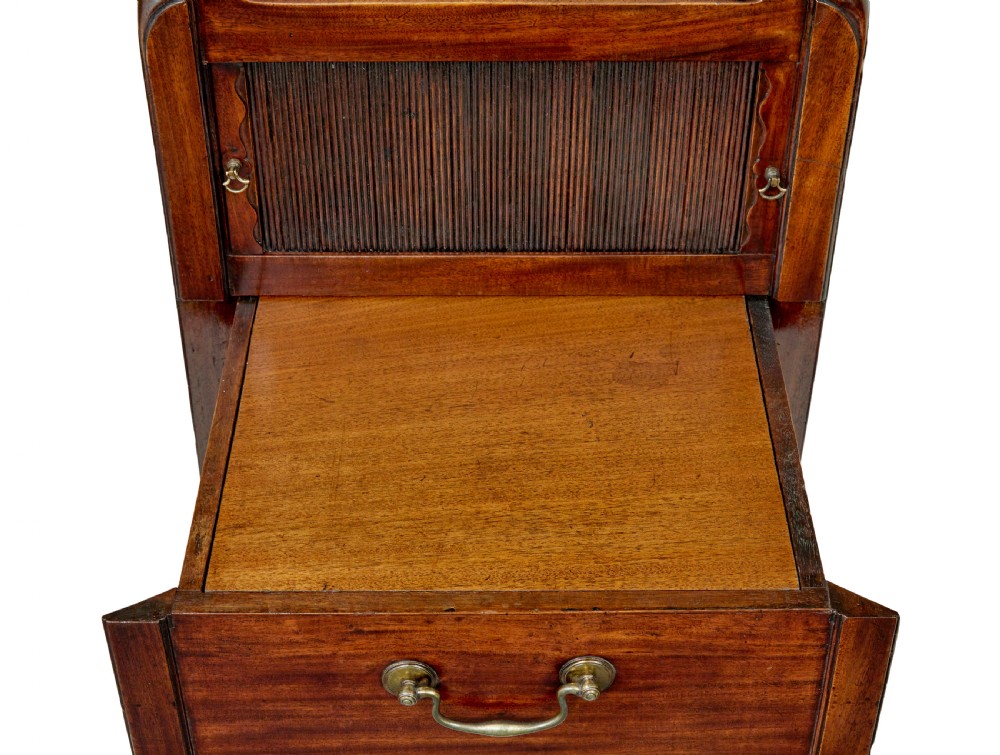 A 19th-century Georgian mahogany bedside table featuring a gallery top with hand-holds, a sliding tambour door, and a drawer with a brass handle. View IX