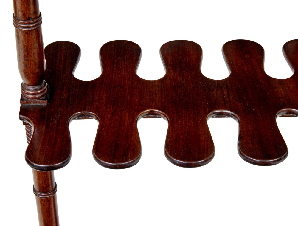 A mid-nineteenth-century dark mahogany wooden riding boot stand featuring turned side supports, upper hanging pegs, a notched central rack, and splayed feet. View IV