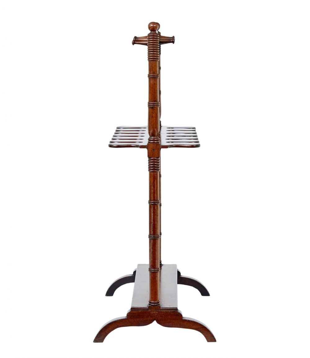 A mid-nineteenth-century dark mahogany wooden riding boot stand featuring turned side supports, upper hanging pegs, a notched central rack, and splayed feet. View VIII
