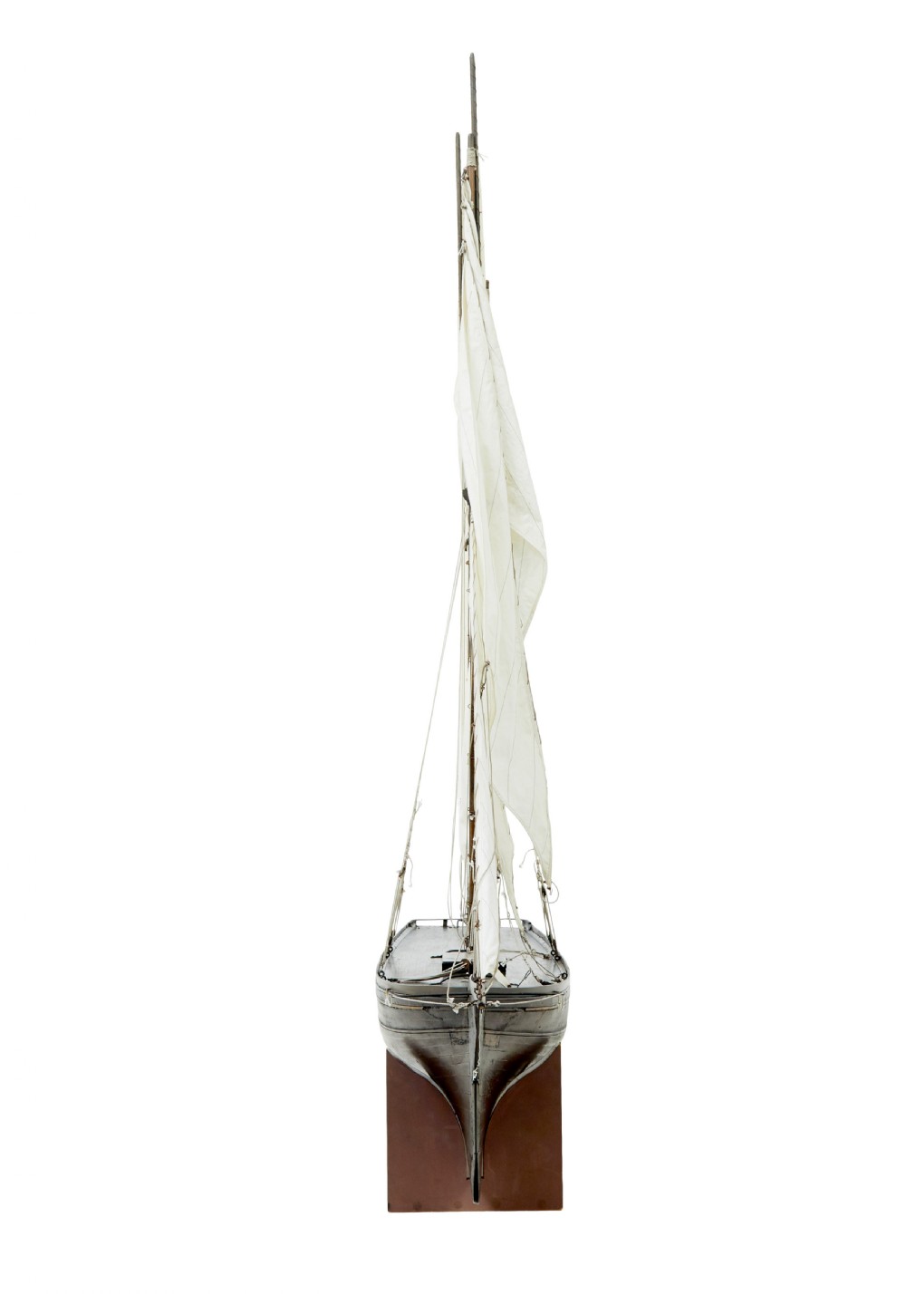A late 19th-century wooden scale model of a two-masted sailing yacht with off-white sails mounted on a wooden stand. View II