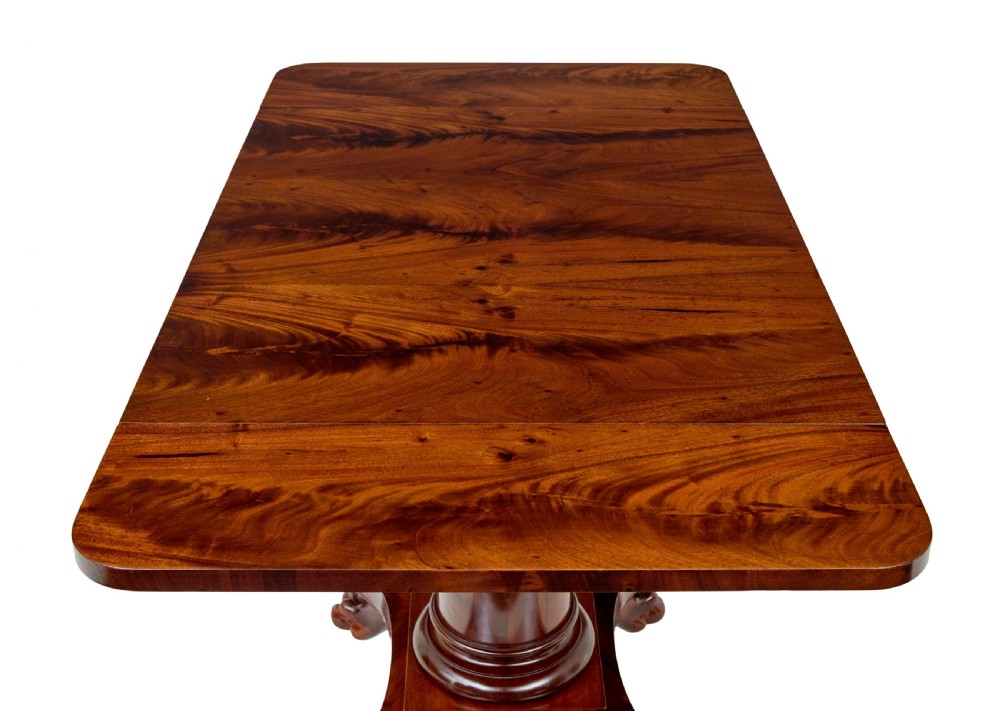 An early 20th-century Scandinavian Empire Revival mahogany sofa table featuring drop leaves, a single frieze drawer, a central cylindrical pedestal, and carved paw feet. View VII