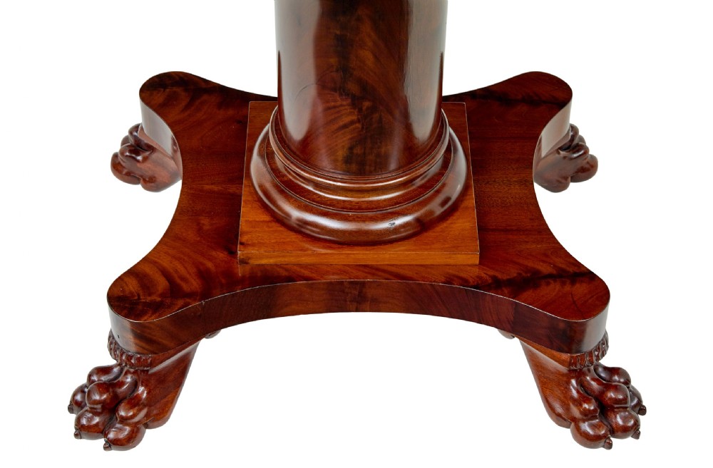 An early 20th-century Scandinavian Empire Revival mahogany sofa table featuring drop leaves, a single frieze drawer, a central cylindrical pedestal, and carved paw feet. View VIII