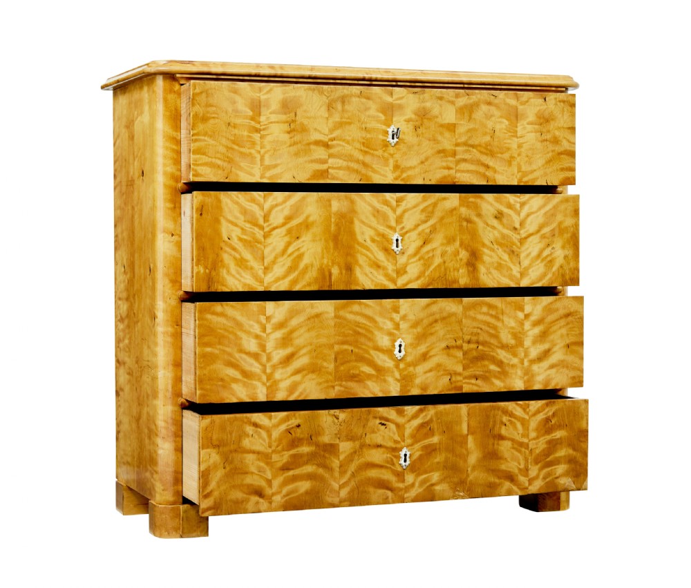 A nineteenth-century Swedish chest of drawers featuring four drawers decorated with book-matched tiger birch veneer and small white escutcheons. View II