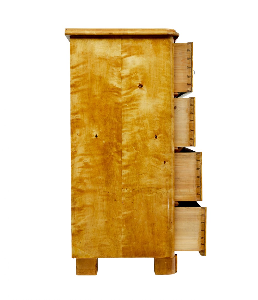 A nineteenth-century Swedish chest of drawers featuring four drawers decorated with book-matched tiger birch veneer and small white escutcheons. View VI