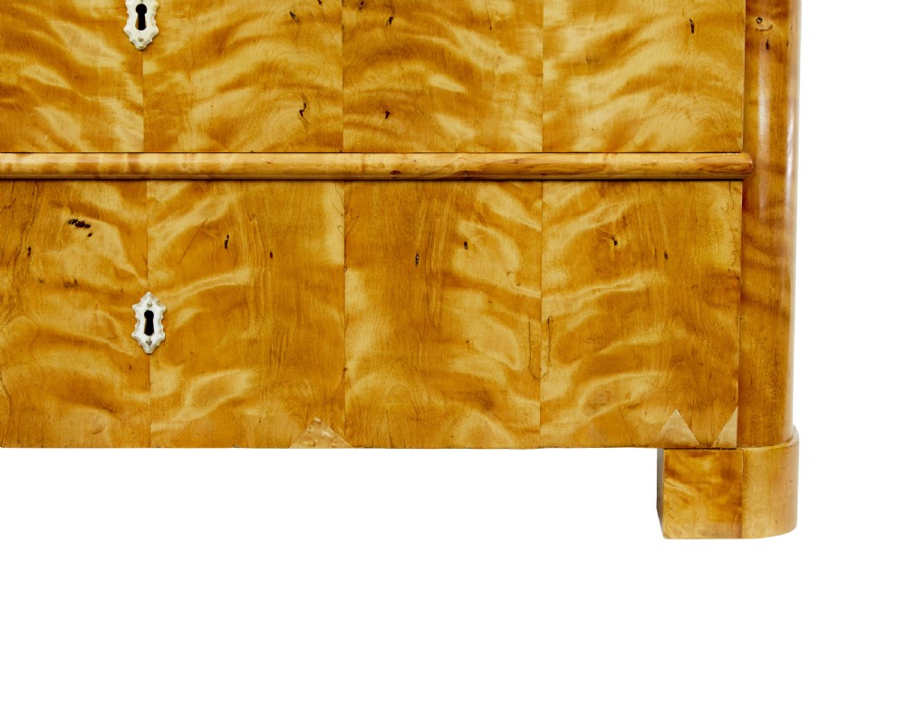 A nineteenth-century Swedish chest of drawers featuring four drawers decorated with book-matched tiger birch veneer and small white escutcheons. View VII