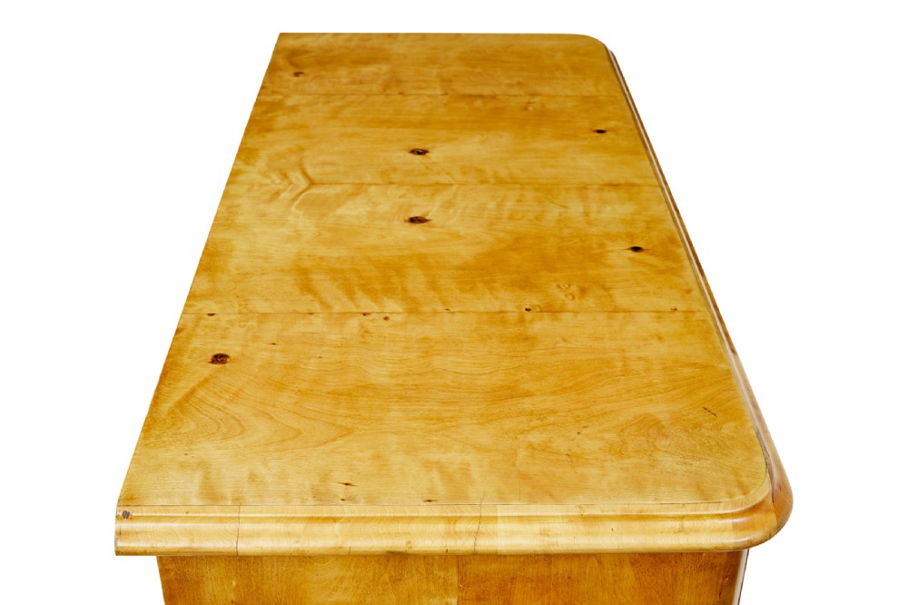 A nineteenth-century Swedish chest of drawers featuring four drawers decorated with book-matched tiger birch veneer and small white escutcheons. View VIII