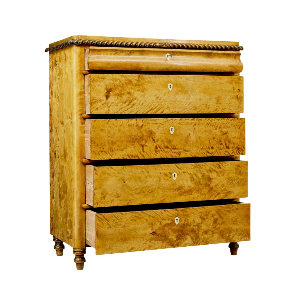 A 19th-century Swedish birch chest featuring five graduated drawers with keyhole escutcheons, rope-carved moulding under the top edge, and turned feet. View II