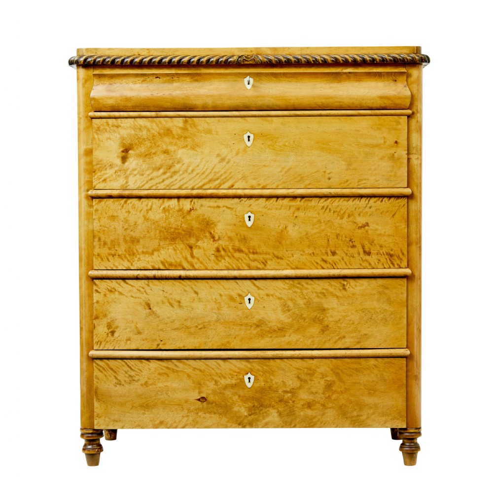 A 19th-century Swedish birch chest featuring five graduated drawers with keyhole escutcheons, rope-carved moulding under the top edge, and turned feet. View IV