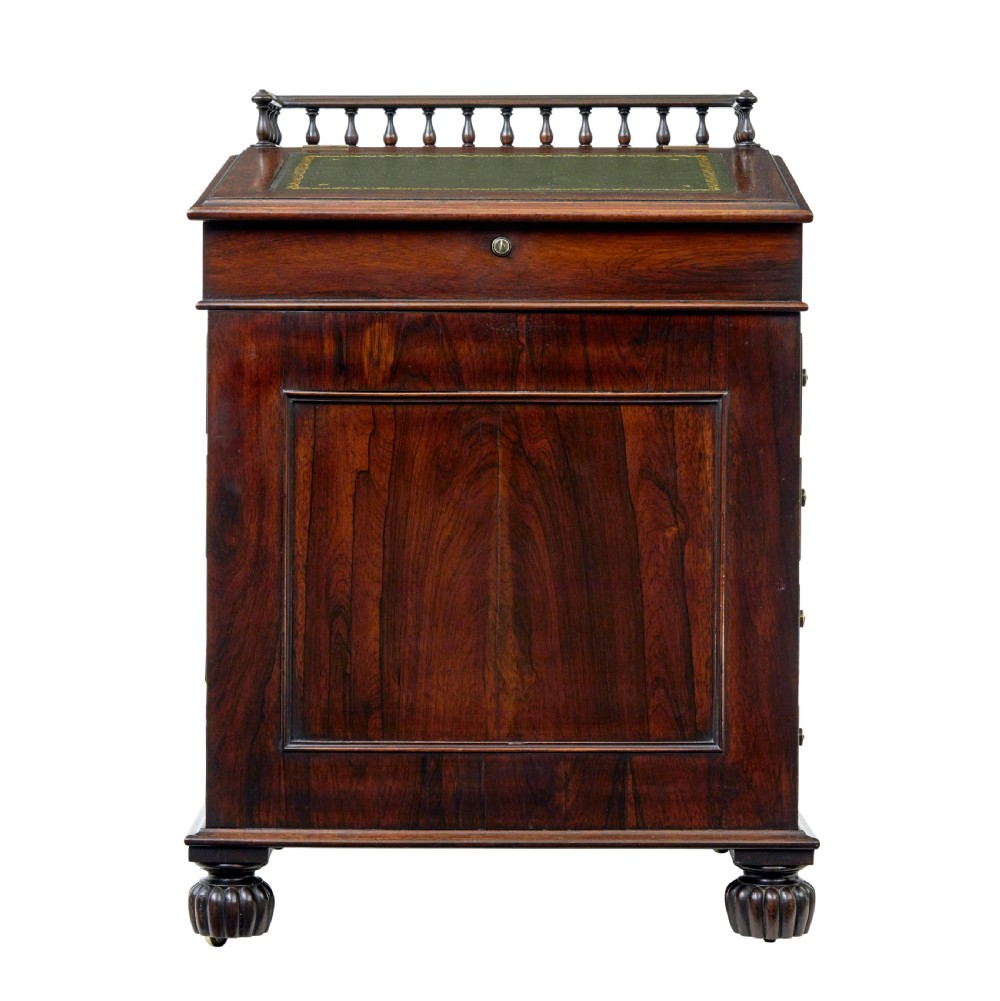 A mid-19th-century dark mahogany Davenport writing desk with a green leather gilded slant top, side drawers, and a balustrade gallery. View III