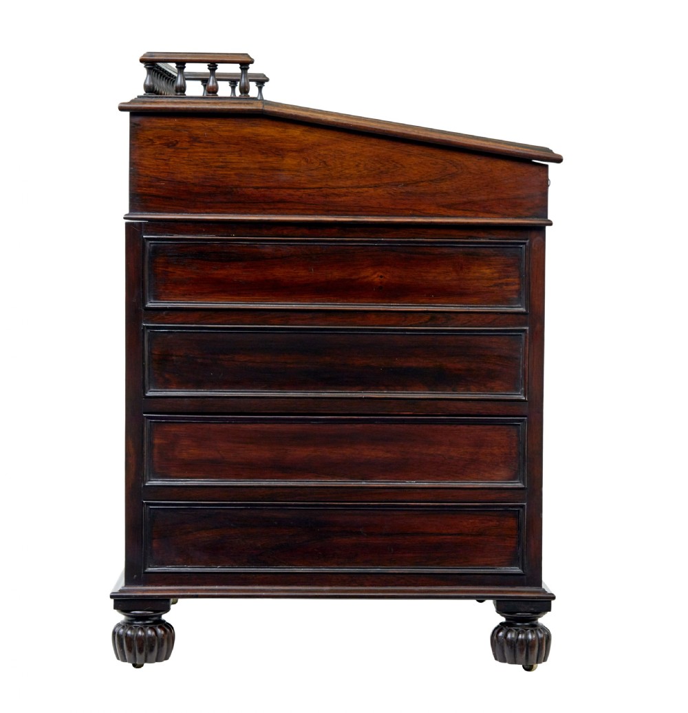 A mid-19th-century dark mahogany Davenport writing desk with a green leather gilded slant top, side drawers, and a balustrade gallery. View VI