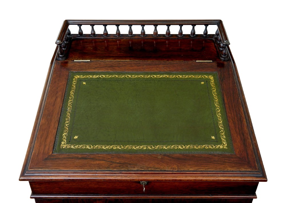 A mid-19th-century dark mahogany Davenport writing desk with a green leather gilded slant top, side drawers, and a balustrade gallery. View VII