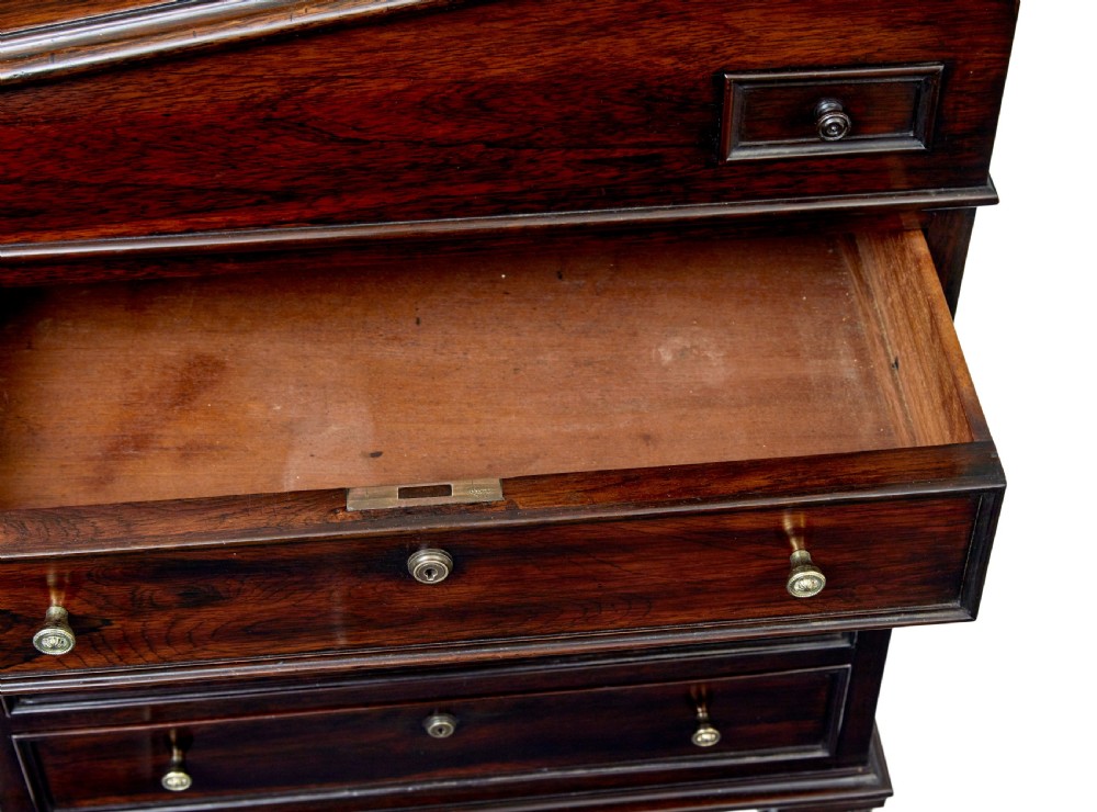 A mid-19th-century dark mahogany Davenport writing desk with a green leather gilded slant top, side drawers, and a balustrade gallery. View XI