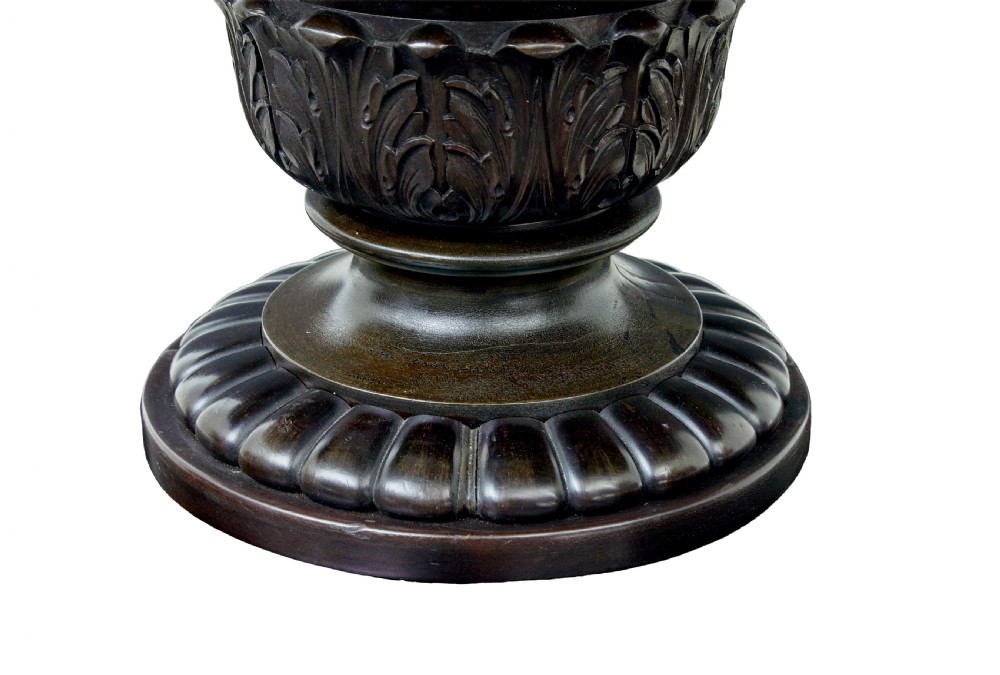 A 19th-century ebonised dark wood oval centre table featuring a fluted central pedestal and a quadform base supported by carved claw feet. View VI
