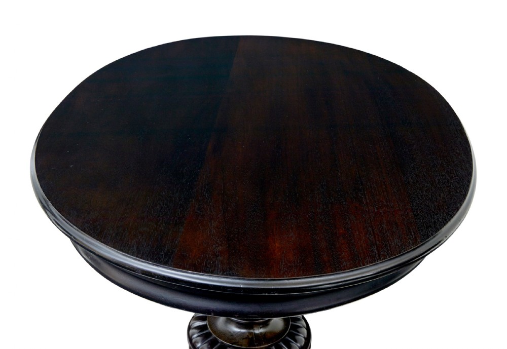 A 19th-century ebonised dark wood oval centre table featuring a fluted central pedestal and a quadform base supported by carved claw feet. View VIII