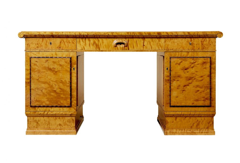 An Art Deco twin-pedestalled desk crafted from golden flame birch veneer featuring multiple drawers, cupboard doors, and decorative reeded borders. View IV