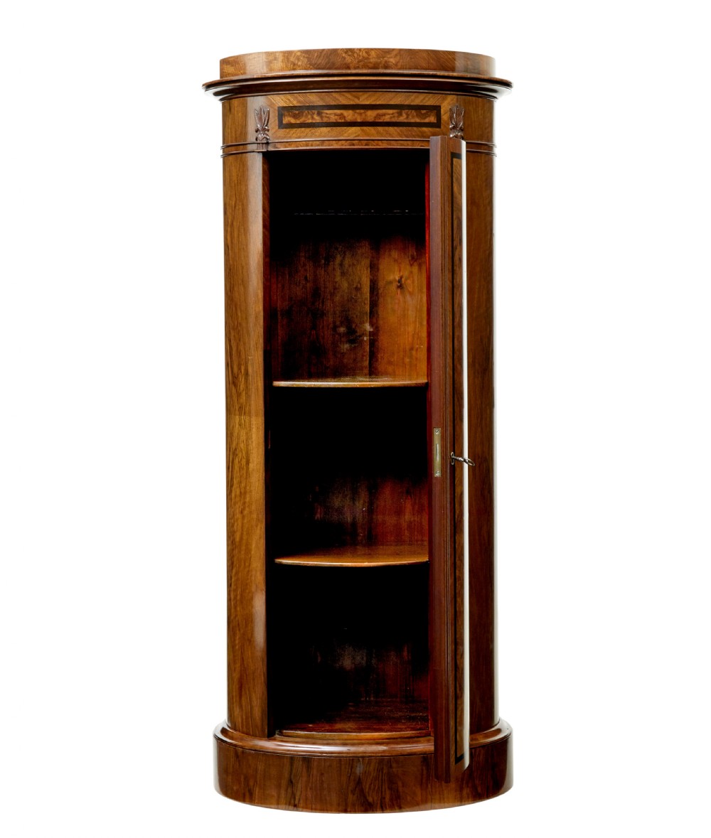 A 19th-century cylindrical burr walnut pedestal cupboard featuring geometric dark stringing and a single door with a key. View II