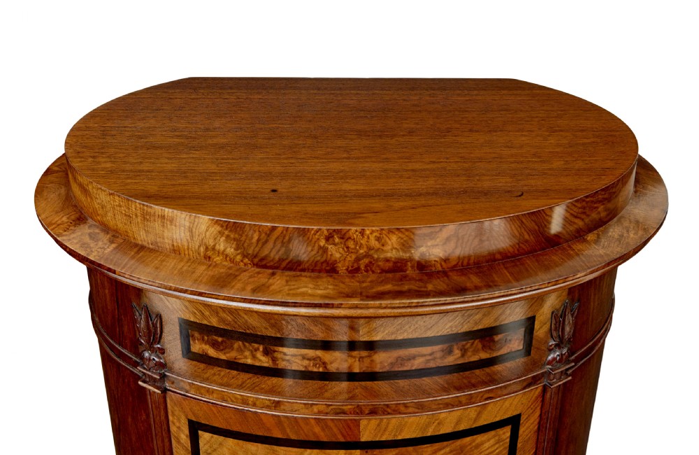 A 19th-century cylindrical burr walnut pedestal cupboard featuring geometric dark stringing and a single door with a key. View VIII