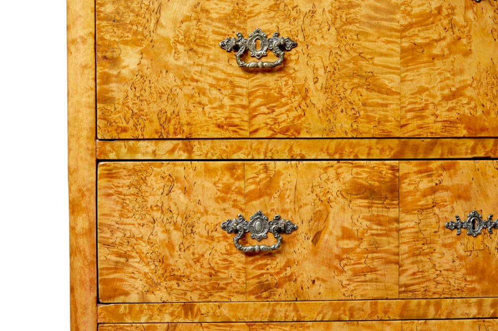 A mid-19th-century Swedish secretaire chest featuring highly figured burr birch veneers, four horizontal drawers, ornate brass handles, and block feet. View VII
