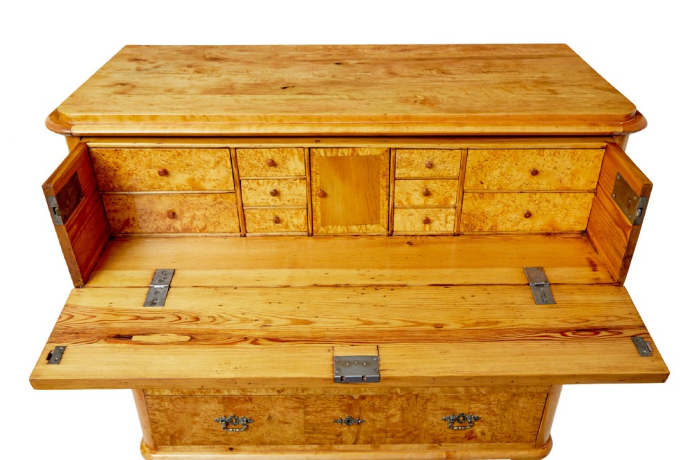 A mid-19th-century Swedish secretaire chest featuring highly figured burr birch veneers, four horizontal drawers, ornate brass handles, and block feet. View VIII