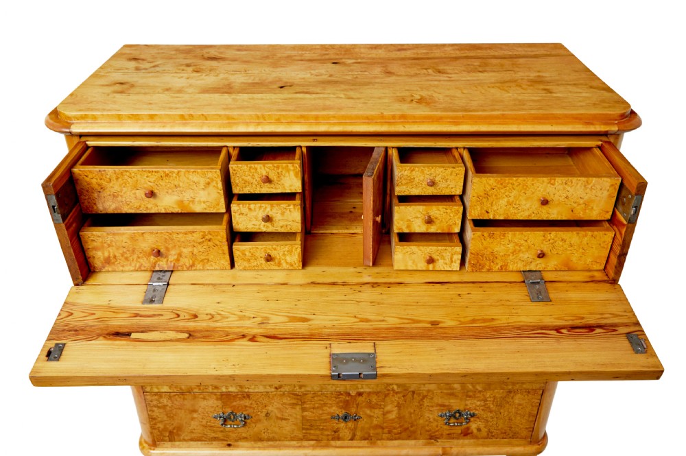 A mid-19th-century Swedish secretaire chest featuring highly figured burr birch veneers, four horizontal drawers, ornate brass handles, and block feet. View IX