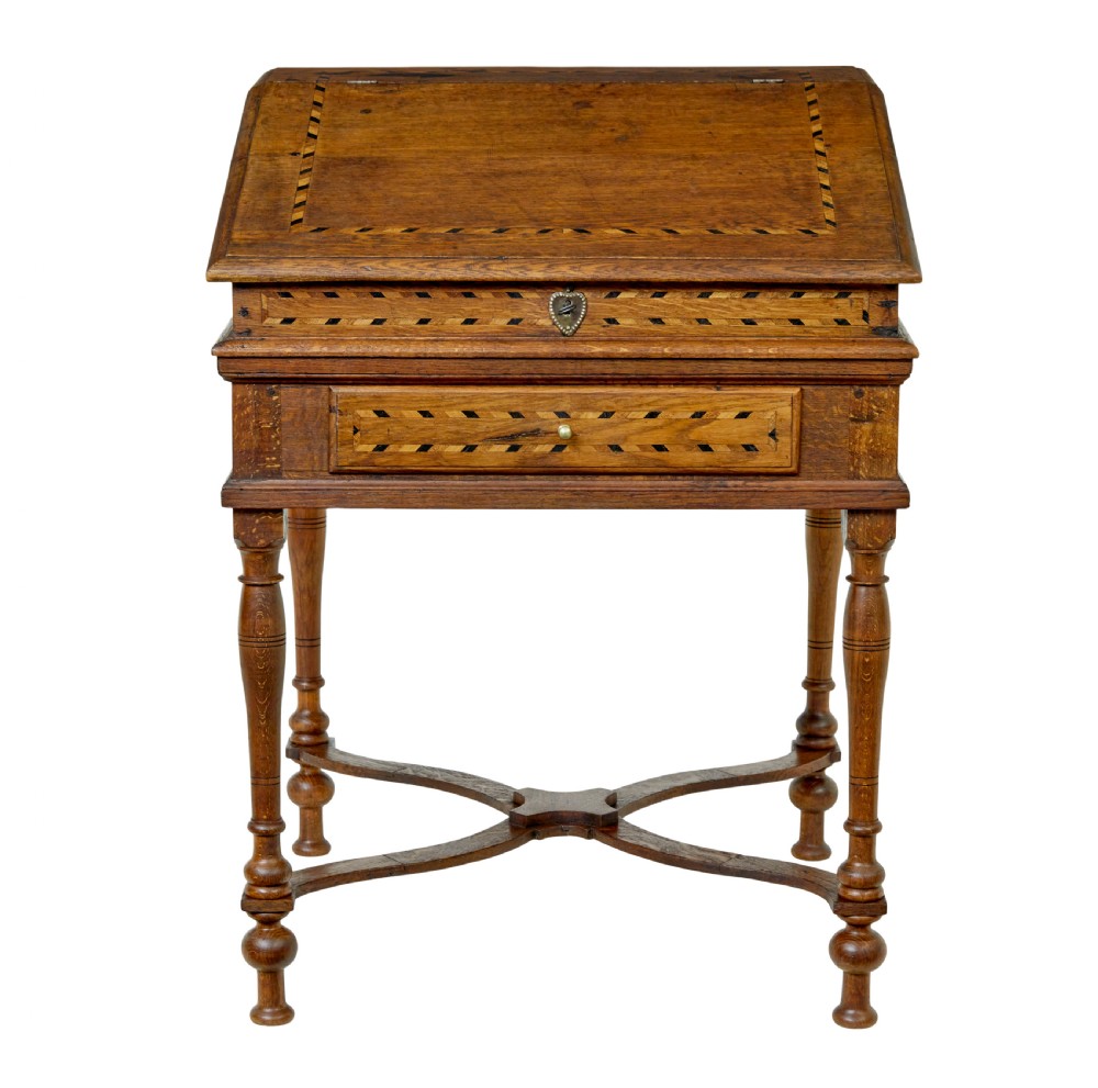 An early 19th-century Dutch oak writing desk on turned legs featuring geometric inlaid borders and a sloped writing lid above a single drawer. View II