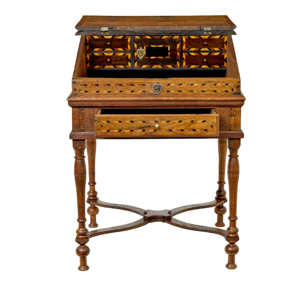 An early 19th-century Dutch oak writing desk on turned legs featuring geometric inlaid borders and a sloped writing lid above a single drawer. View III