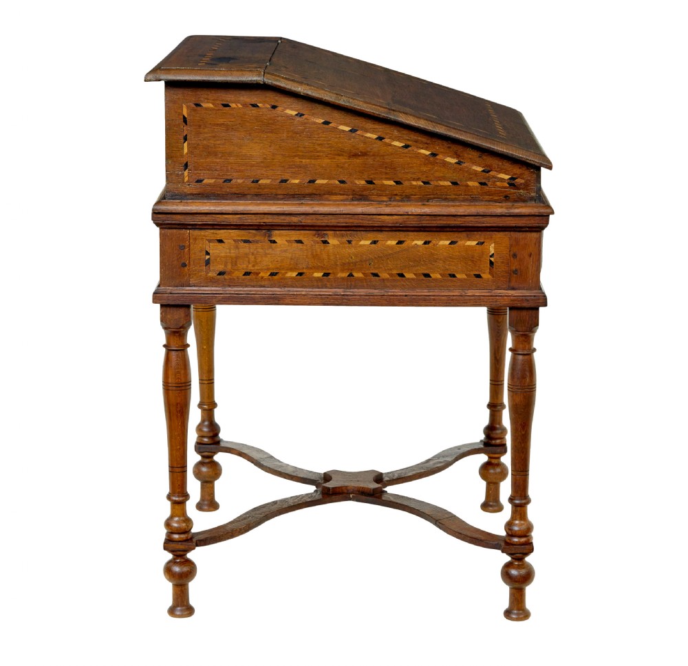 An early 19th-century Dutch oak writing desk on turned legs featuring geometric inlaid borders and a sloped writing lid above a single drawer. View VI
