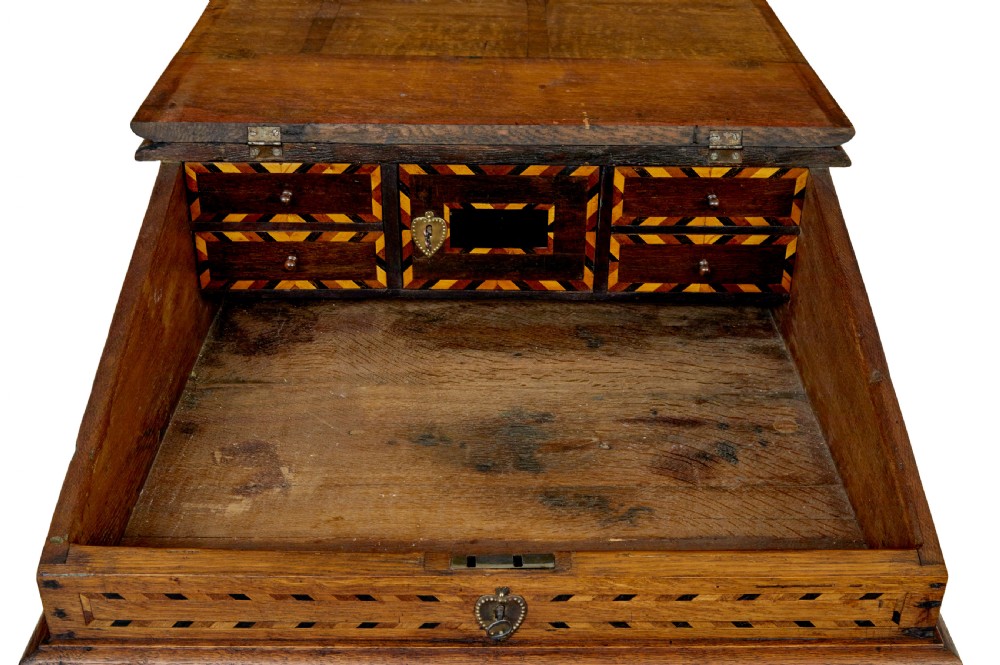 An early 19th-century Dutch oak writing desk on turned legs featuring geometric inlaid borders and a sloped writing lid above a single drawer. View IX