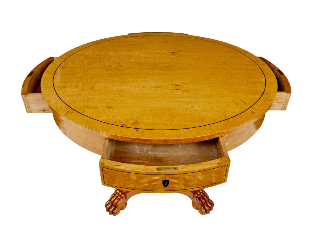 A circular 19th-century Swedish flame birch centre table featuring a single frieze drawer, a central cylindrical pedestal, and a shaped quadruped base resting on carved claw feet. View III