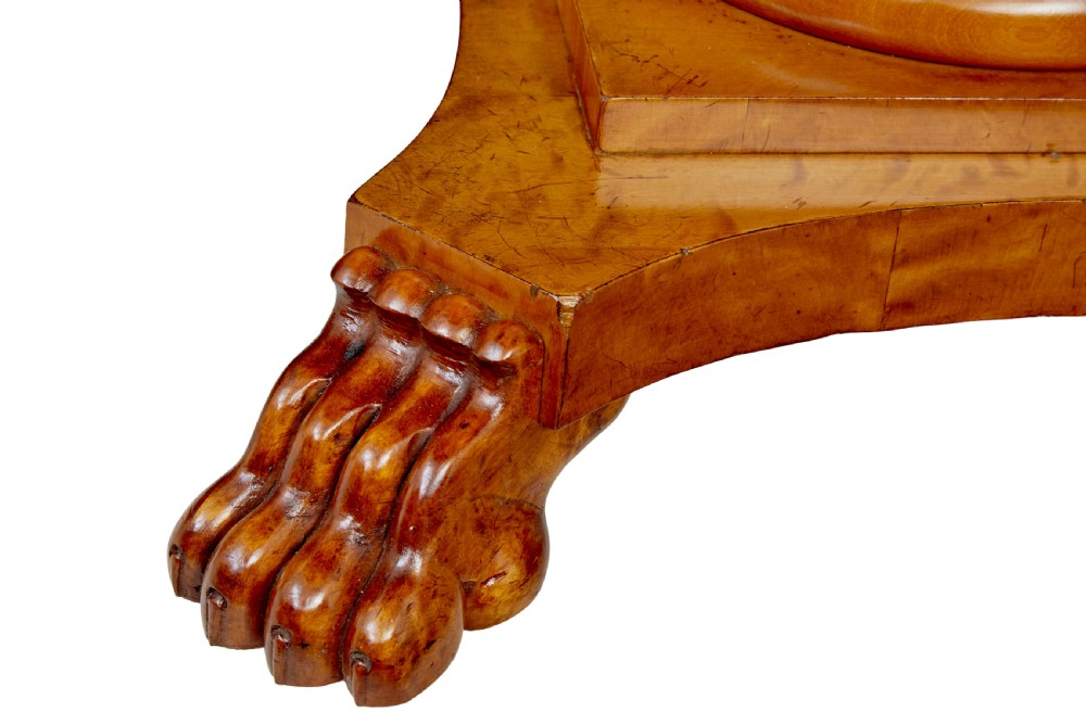 A circular 19th-century Swedish flame birch centre table featuring a single frieze drawer, a central cylindrical pedestal, and a shaped quadruped base resting on carved claw feet. View VII
