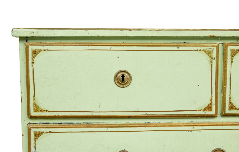 A 19th-century Swedish sage green painted pine chest of drawers with two short drawers over three long drawers and brass keyhole escutcheons. View XI