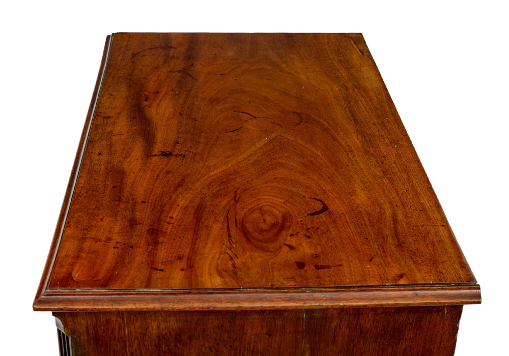 An early 19th-century Georgian mahogany chest of drawers featuring four graduated drawers with brass swan-neck handles and bracket feet. View III