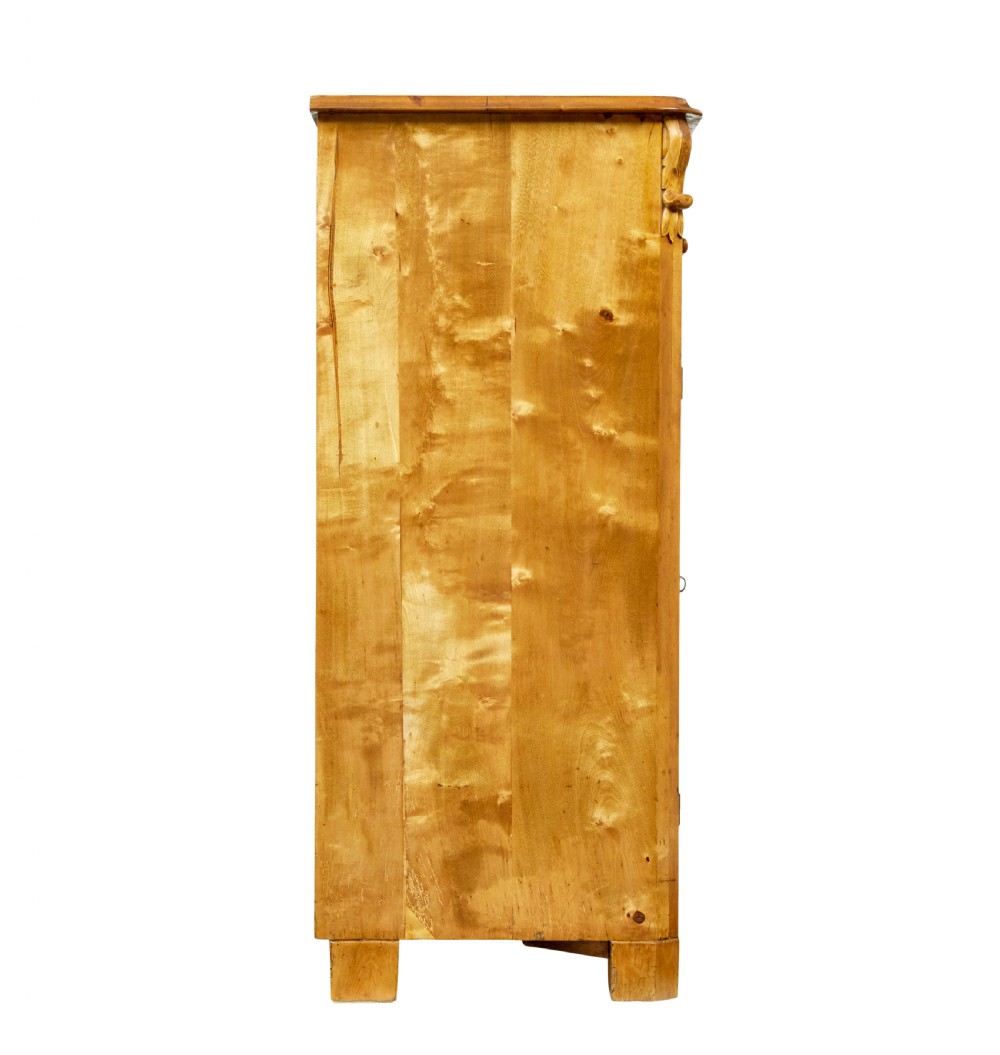 A nineteenth-century Swedish two-door cupboard constructed from golden tiger birch wood with two upper drawers and carved corner corbels. View VI