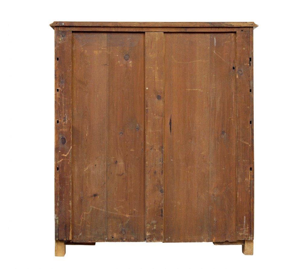 A nineteenth-century Swedish two-door cupboard constructed from golden tiger birch wood with two upper drawers and carved corner corbels. View VII
