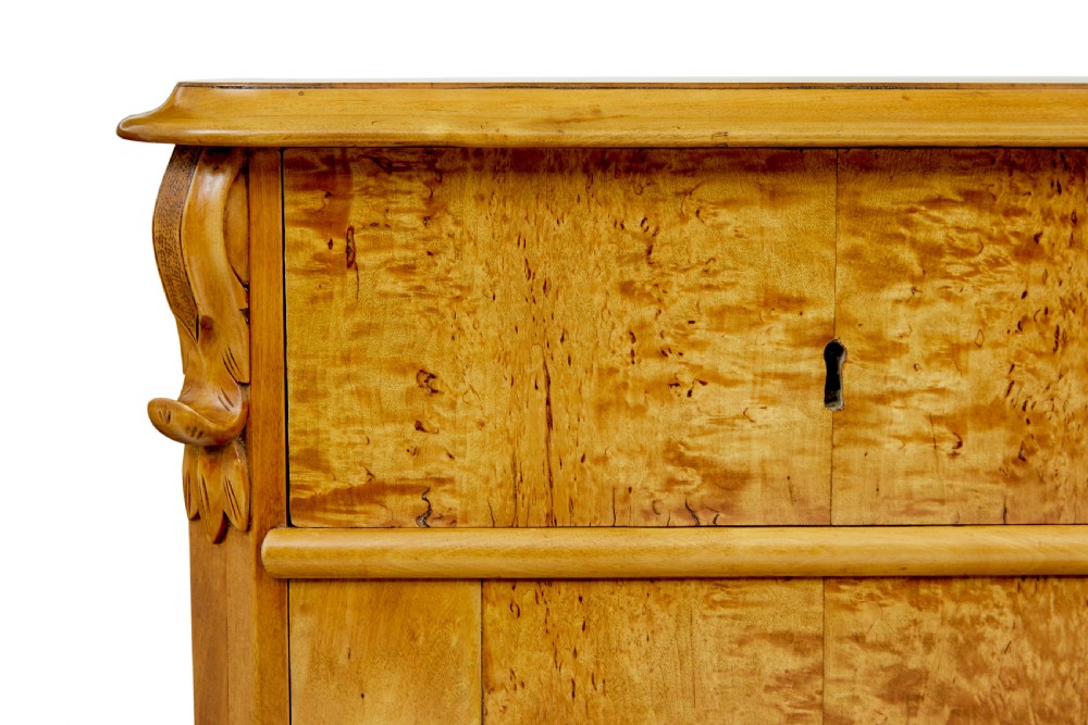 A nineteenth-century Swedish two-door cupboard constructed from golden tiger birch wood with two upper drawers and carved corner corbels. View IX