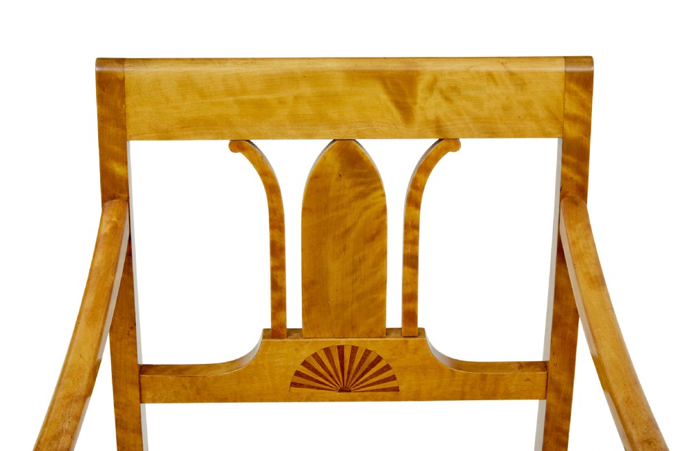 A pair of Art Deco Scandinavian birch armchairs featuring curved armrests, ebonised turned supports, inlaid back splats, and black leather studded seats. View VI
