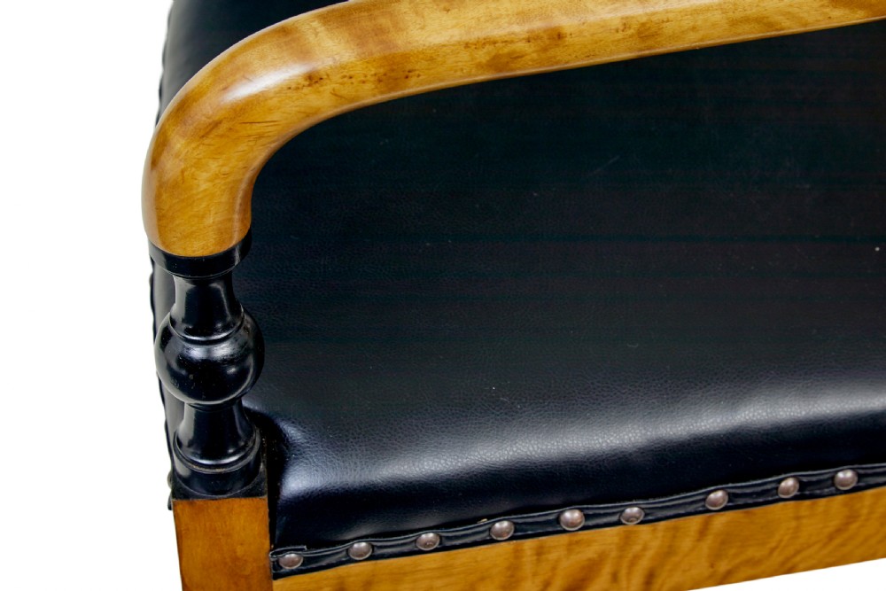 A pair of Art Deco Scandinavian birch armchairs featuring curved armrests, ebonised turned supports, inlaid back splats, and black leather studded seats. View VII