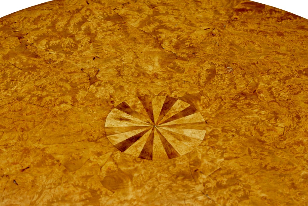 A mid-19th-century Swedish circular occasional table featuring a burr birch top with central star inlay, supported by a turned pedestal stem and tripod legs. View IV