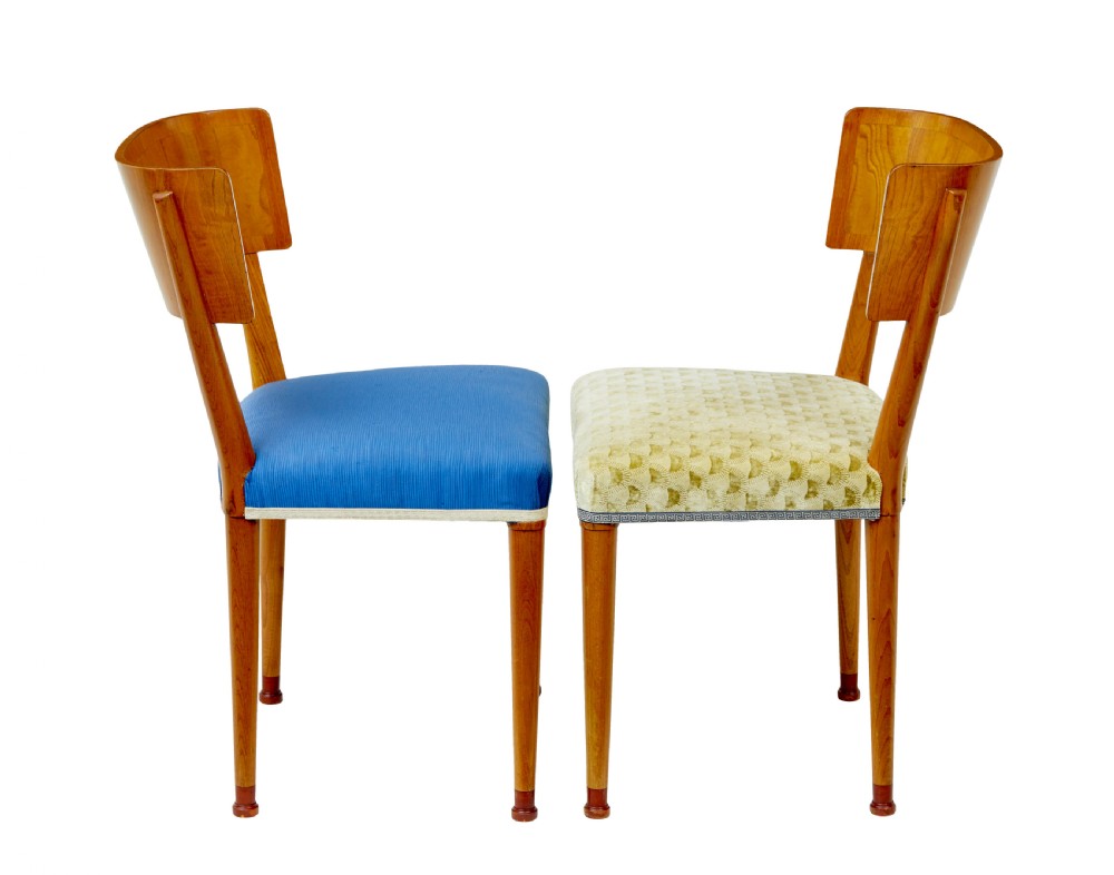 A set of Swedish Art Deco elm klismos dining chairs featuring curved backrests with marquetry inlays and upholstered seats in blue and patterned fabrics. View IV