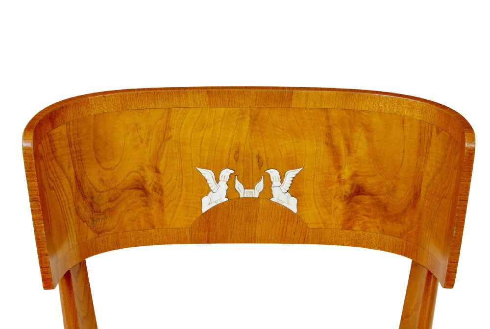 A set of Swedish Art Deco elm klismos dining chairs featuring curved backrests with marquetry inlays and upholstered seats in blue and patterned fabrics. View VI