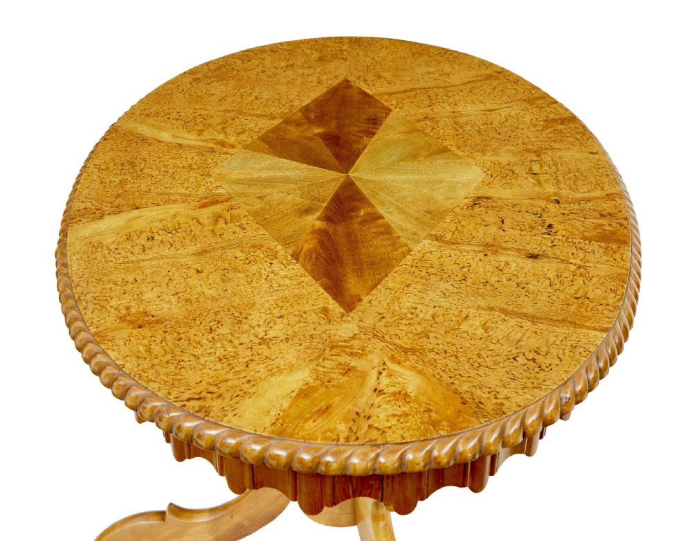 A 19th-century Swedish burr birch occasional table with a segmented veneer top, scalloped apron, turned central column, and tripod scroll feet. View II