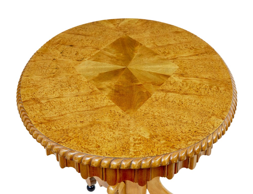 A 19th-century Swedish burr birch occasional table with a segmented veneer top, scalloped apron, turned central column, and tripod scroll feet. View III