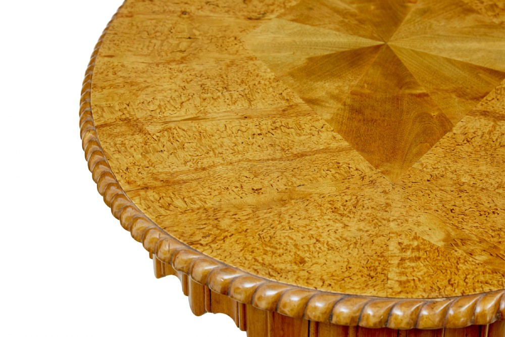 A 19th-century Swedish burr birch occasional table with a segmented veneer top, scalloped apron, turned central column, and tripod scroll feet. View IV
