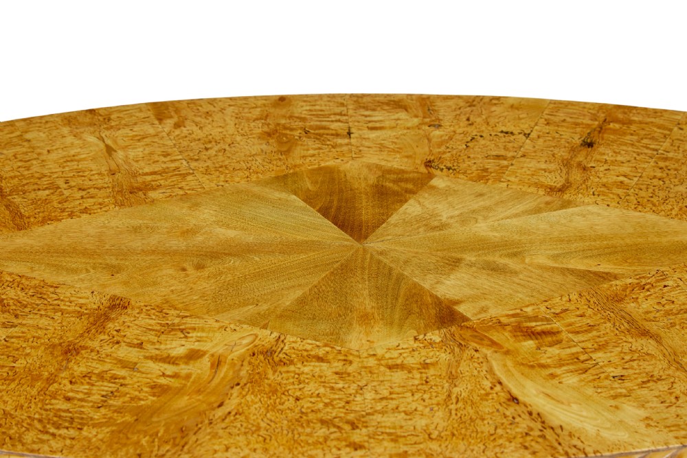 A 19th-century Swedish burr birch occasional table with a segmented veneer top, scalloped apron, turned central column, and tripod scroll feet. View V