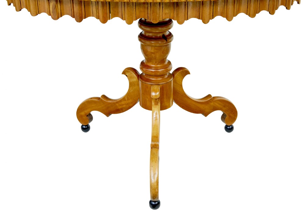 A 19th-century Swedish burr birch occasional table with a segmented veneer top, scalloped apron, turned central column, and tripod scroll feet. View VII