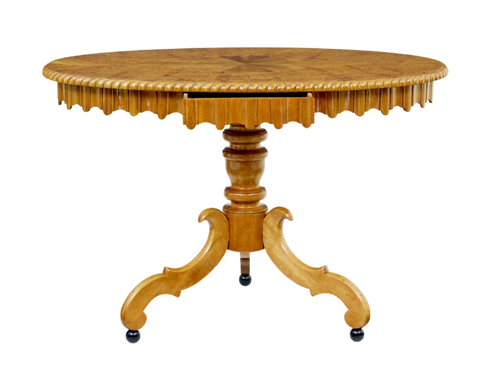 A 19th-century Swedish burr birch occasional table with a segmented veneer top, scalloped apron, turned central column, and tripod scroll feet. View VIII