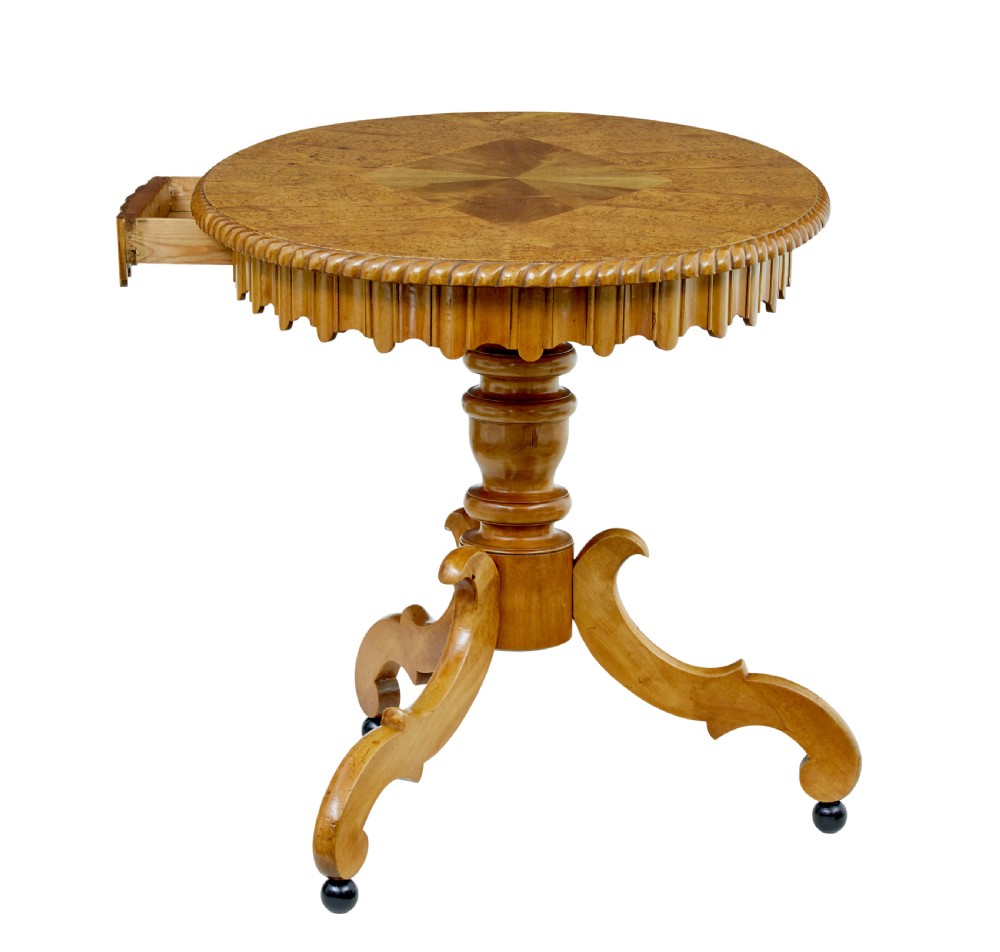 A 19th-century Swedish burr birch occasional table with a segmented veneer top, scalloped apron, turned central column, and tripod scroll feet. View IX