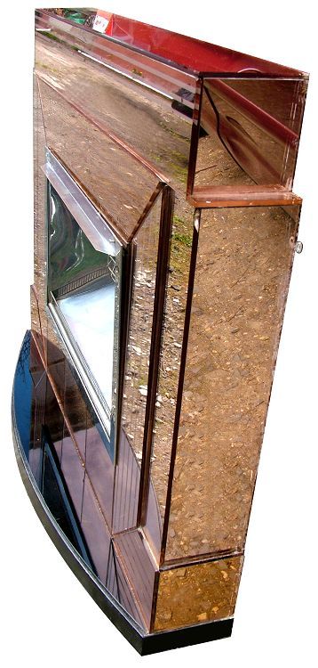 fig 1. A 1930s Art Deco fire surround featuring peach-tinted mirrored glass panels with etched geometric lines and a central chrome electric heating element insert.